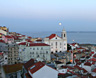 The red-hued moon ascends above Lisbon's lower town, Pombalina