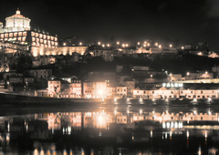 The Douro river reflects the town of Vila Nova de Gaia (or simply Gaia), famous for its aged Port wine, as viewed from the banks of Porto