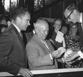 Soviet Premier Nikita Khrushchev chats with a guide. Vice President Richard M. Nixon is at left.